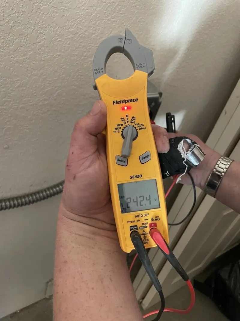 Voltage testing with clamp meter during Ceiling Fan Installation in Covington